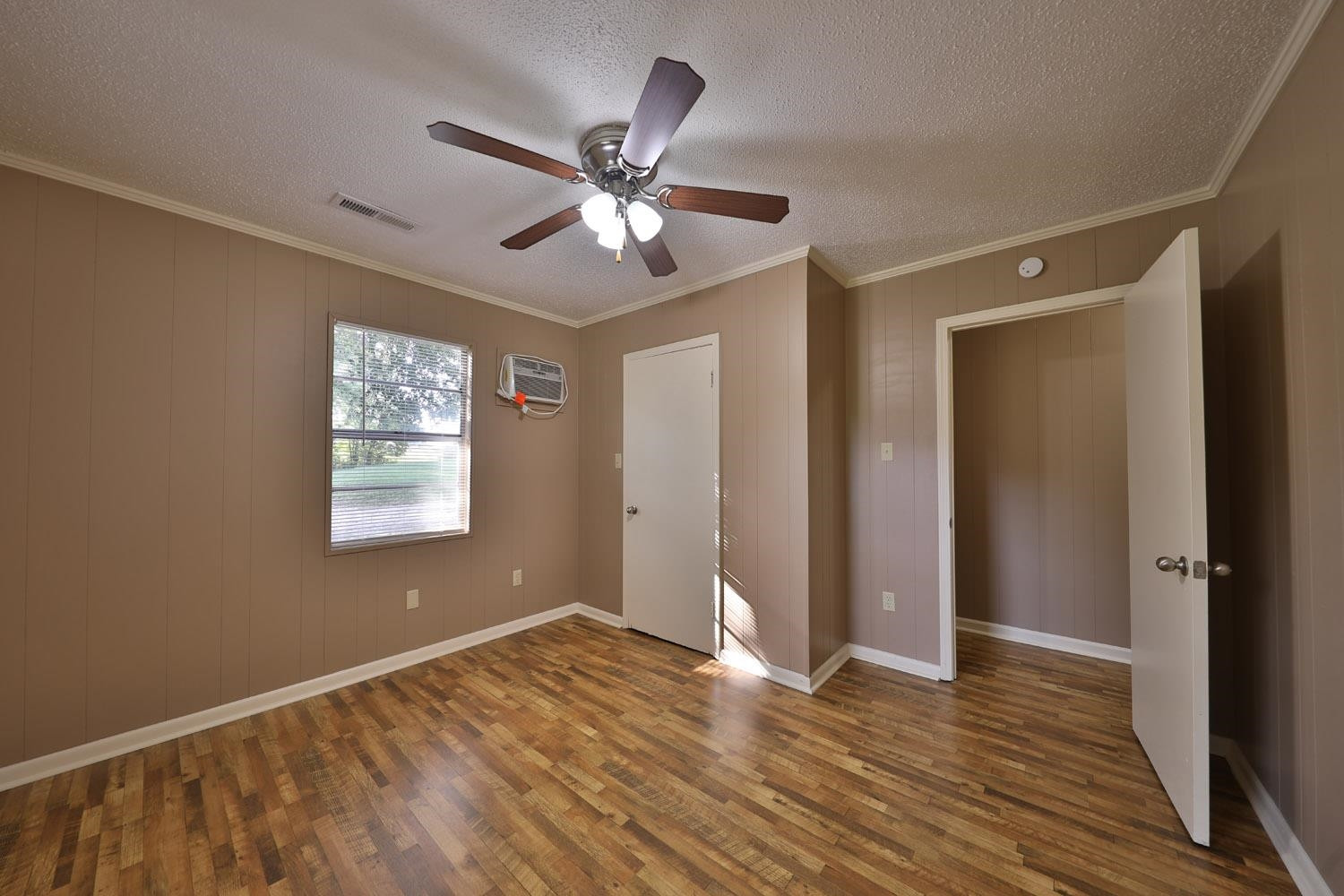 707 Baker Road Martin, TN 38237 - Photo 22 of 32 a view of an empty room with wooden floor and a window