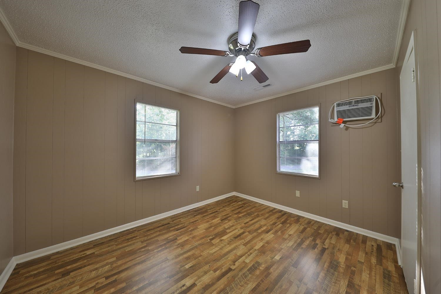 707 Baker Road Martin, TN 38237 - Photo 10 of 32 a view of an empty room with wooden floor and a window