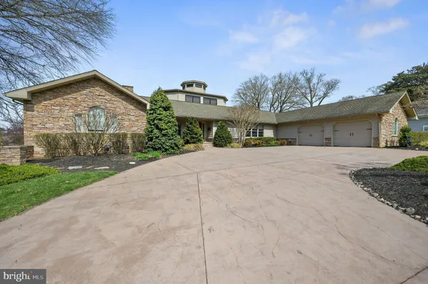 a front view of a house with a yard and potted plants