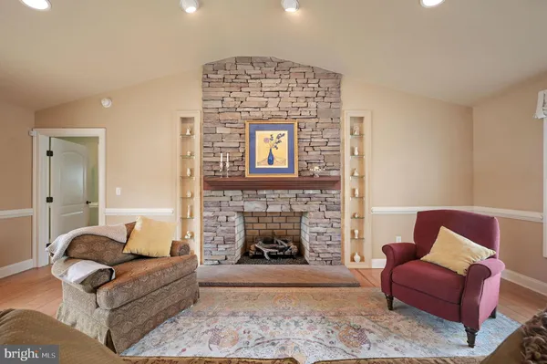 a dining room with furniture a chandelier and wooden floor