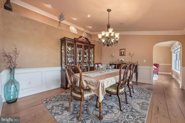 a kitchen with a stove a refrigerator and a wooden floor