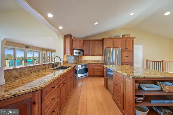 a kitchen with stainless steel appliances granite countertop a stove and a sink