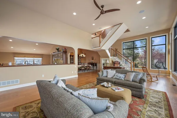 a living room with large windows and furniture