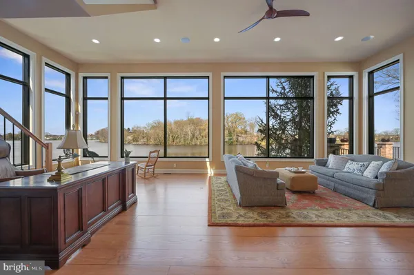 a living room with furniture and a floor to ceiling window