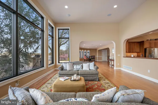 a living room with furniture and a floor to ceiling window
