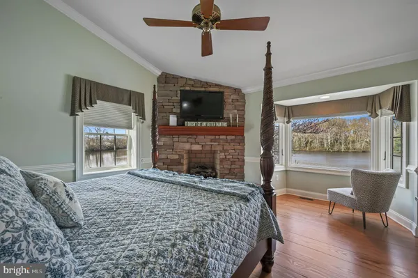 a living room with wooden stairs and a large window