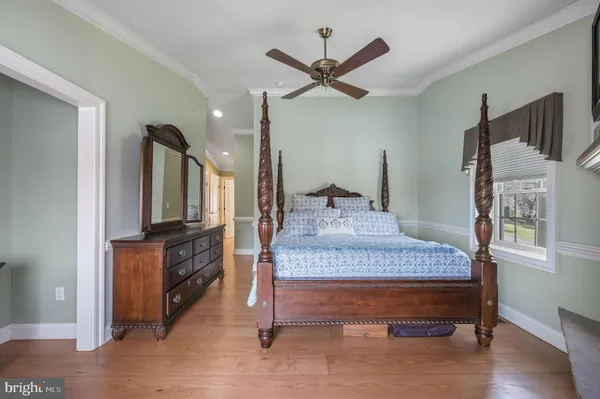 a living room with fireplace furniture and a large window