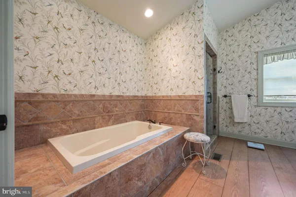 a living room with furniture wooden floor and a large window