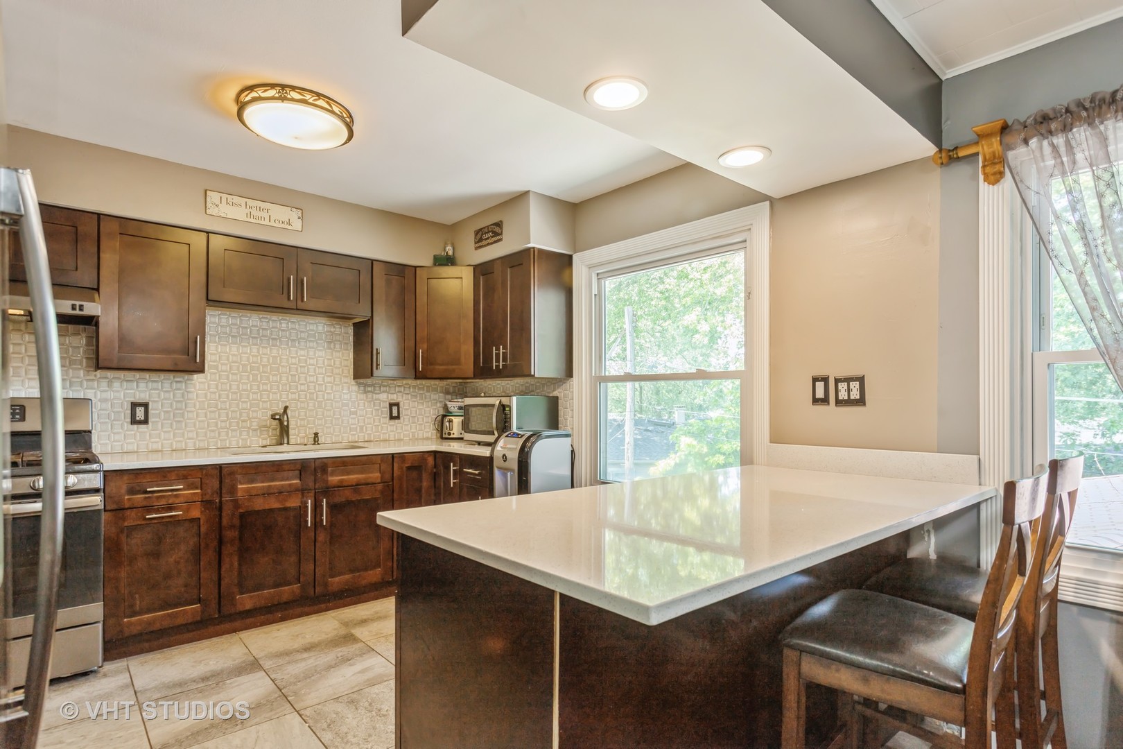 305 Stuart Road Lockport, IL 60441 - Photo 3 of 15 a kitchen with a table chairs sink and cabinets