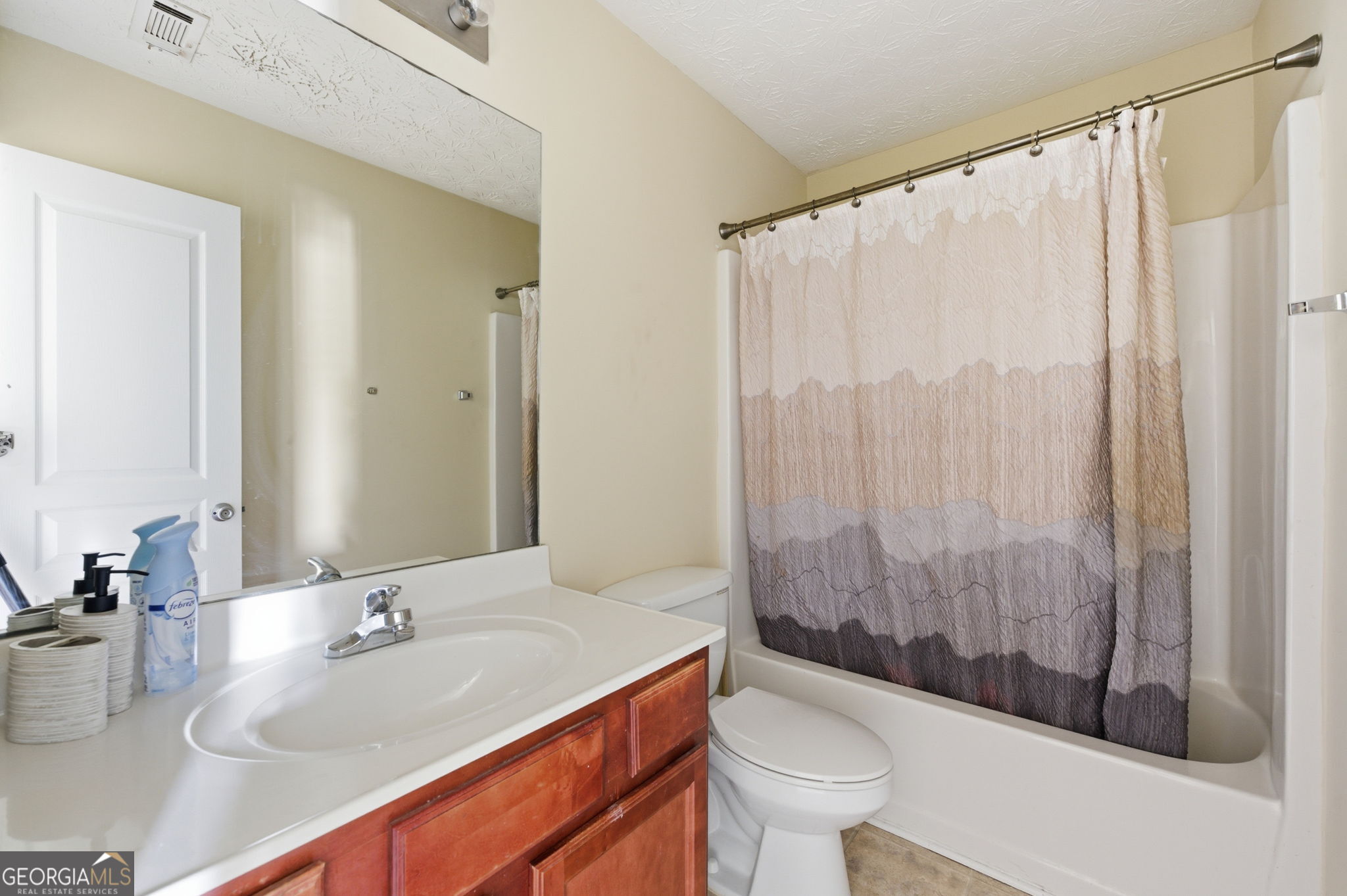 6022 Centennial Run Atlanta, GA 30349 - Photo 20 of 23 a bathroom with a sink and a mirror