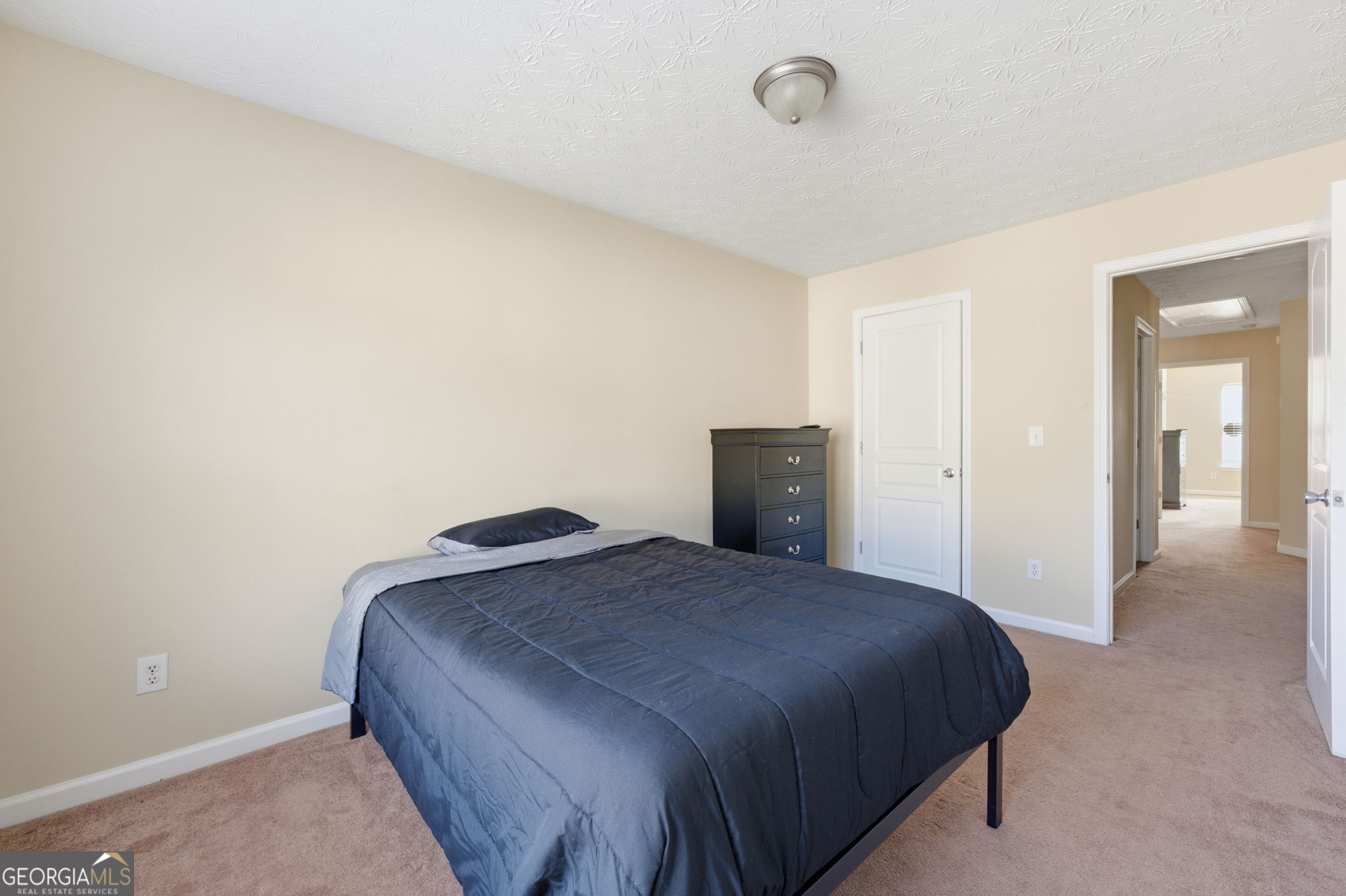 6022 Centennial Run Atlanta, GA 30349 - Photo 21 of 23 a bedroom with a bed and a night stand