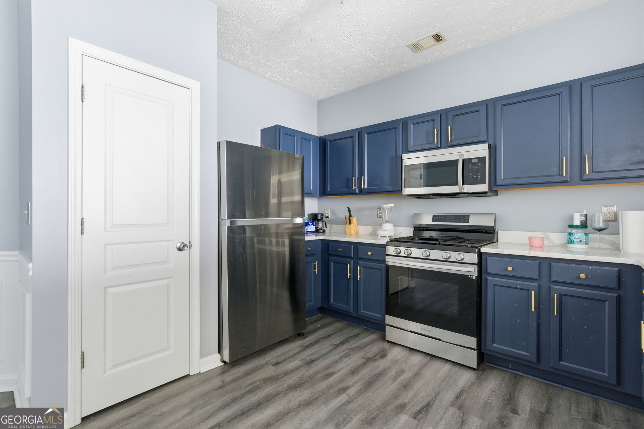 6022 Centennial Run Atlanta, GA 30349 - Photo 6 of 23 a kitchen with stainless steel appliances granite countertop a refrigerator stove and sink