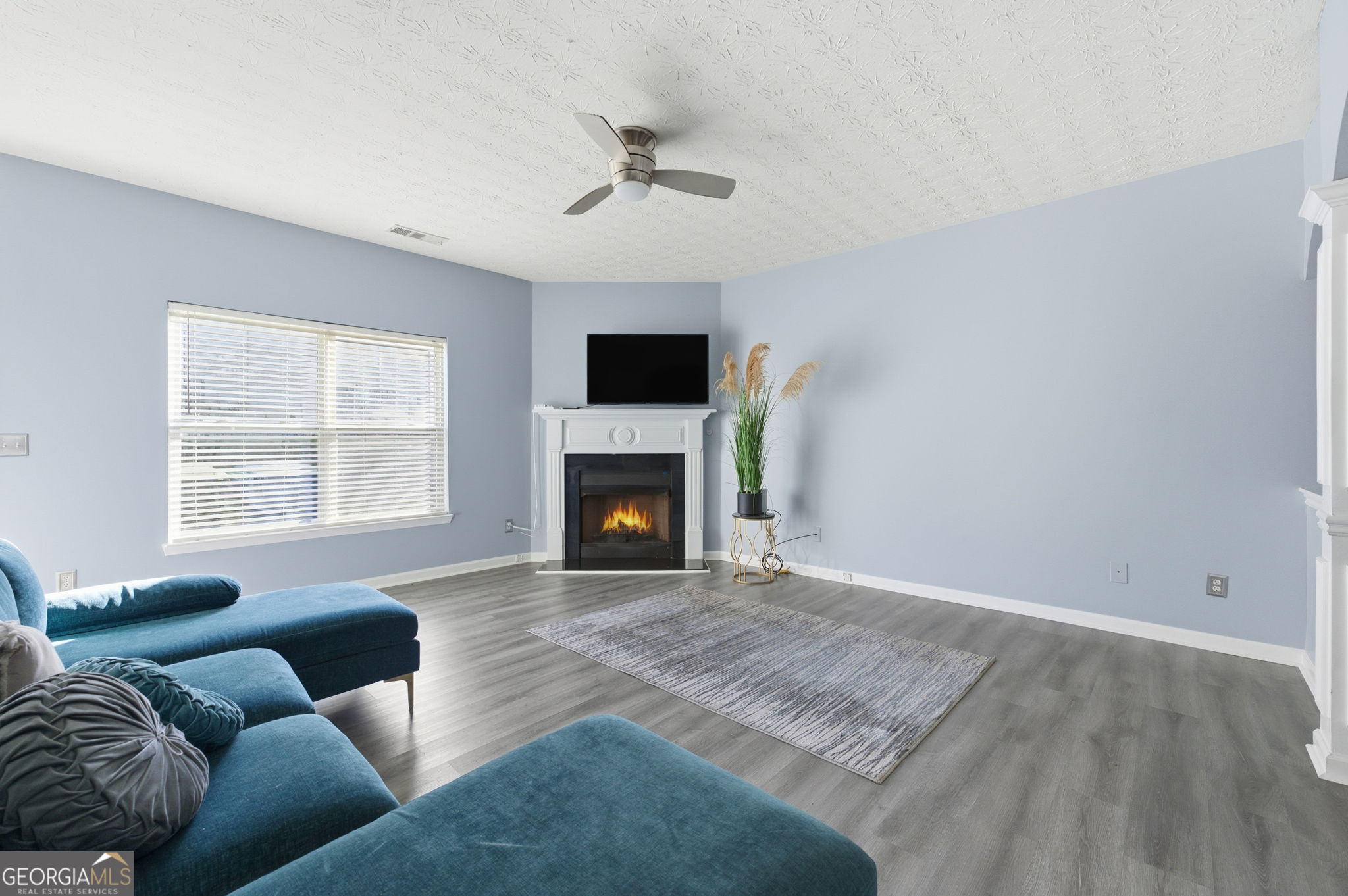 6022 Centennial Run Atlanta, GA 30349 - Photo 10 of 23 a living room with furniture window and a fireplace