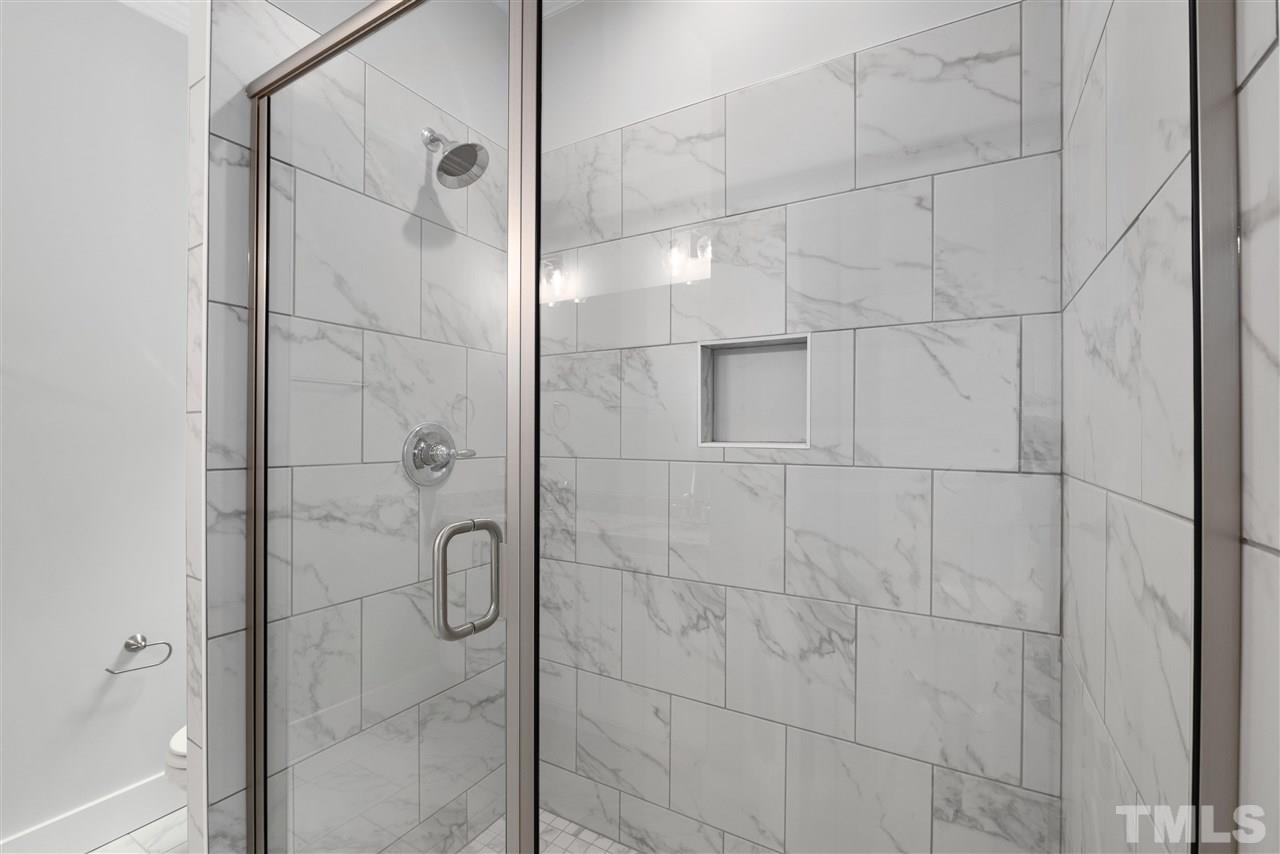 704 Rochester Street Durham, NC 27704 - Photo 20 of 30 Large walk in shower w/tile surround, built in niche, tile flooring and Calcutta white granite counters!