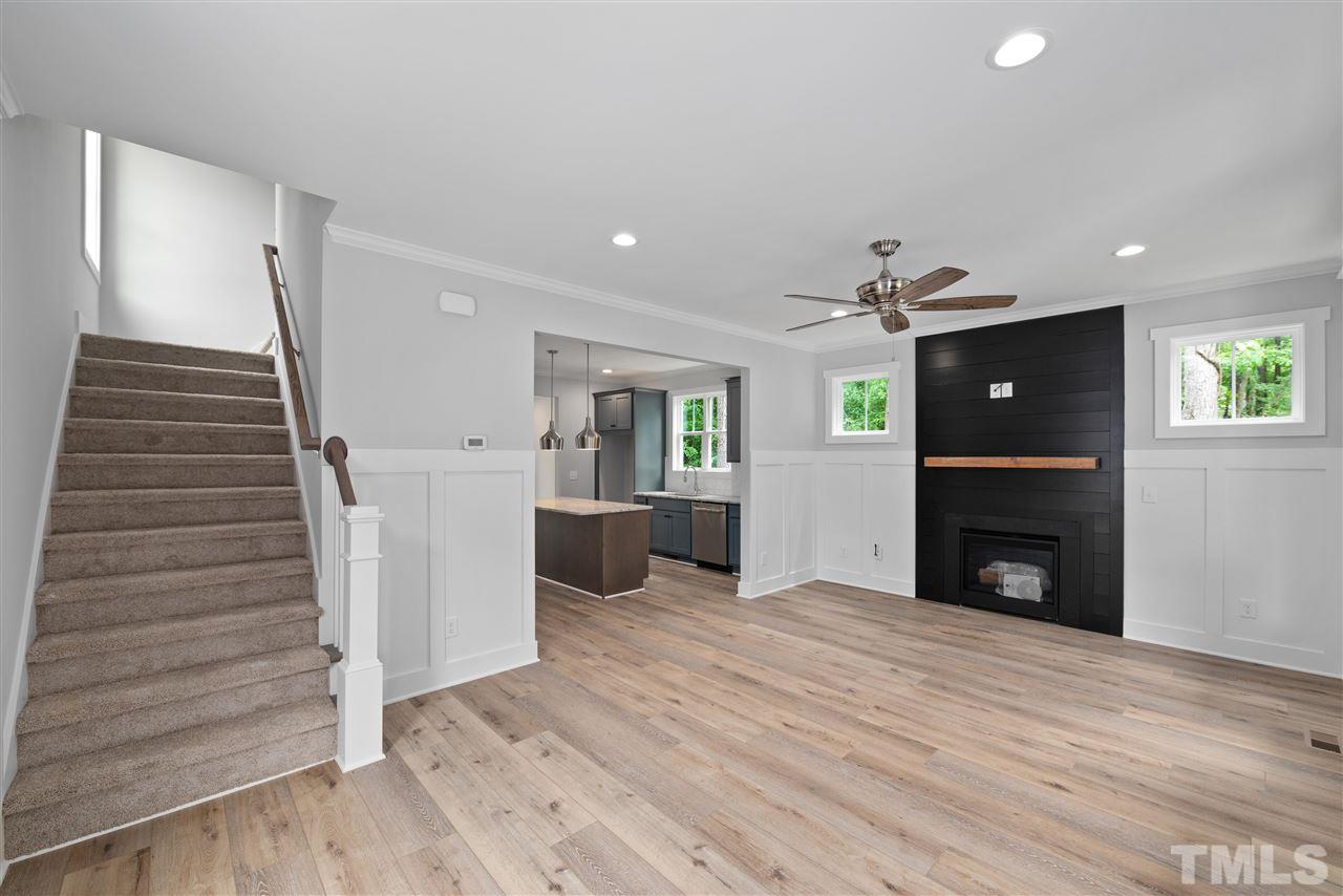 704 Rochester Street Durham, NC 27704 - Photo 5 of 30 Gas fireplace with shiplap surround and floating cypress wood mantle - locally sourced