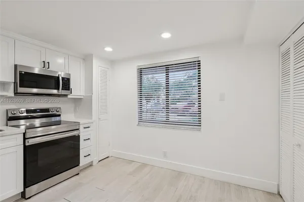 a kitchen with a stove and a microwave