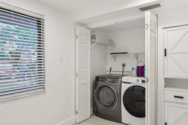a view of a storage & utility room with dryer and washer