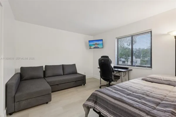a bedroom with a bed and a chair