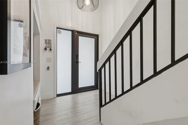 a view of an entryway with wooden floor
