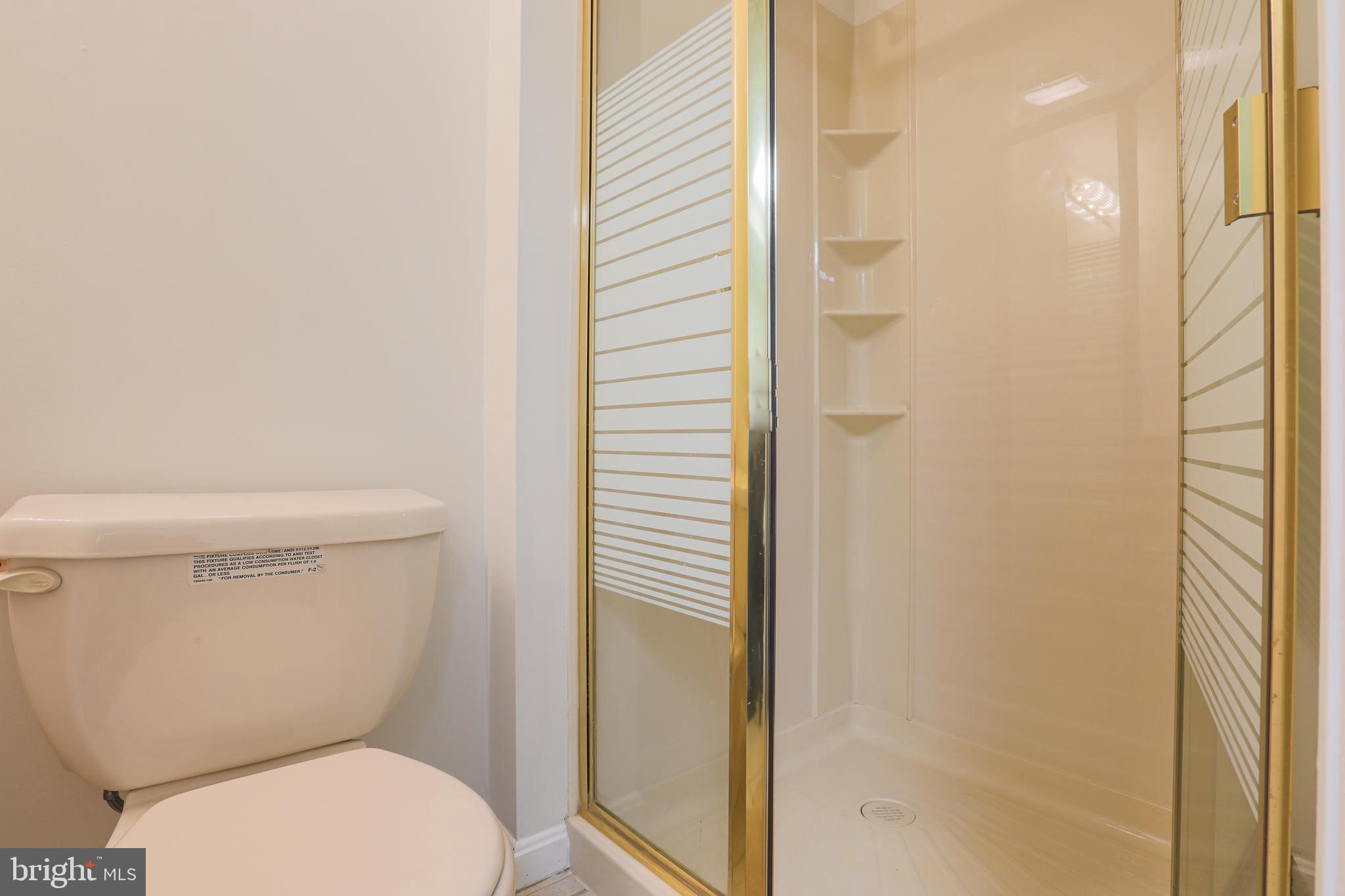 9547 Hallhurst Road Baltimore, MD 21236 - Photo 27 of 49 a white toilet sitting next to a shower