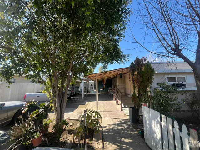 a view of house with outdoor seating and green space