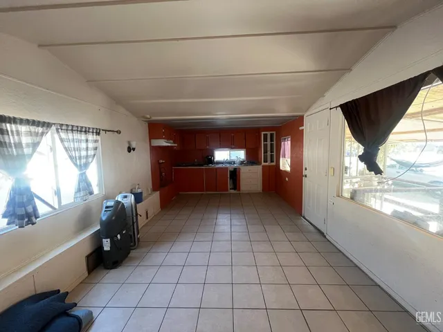 a view of empty room with window and furniture