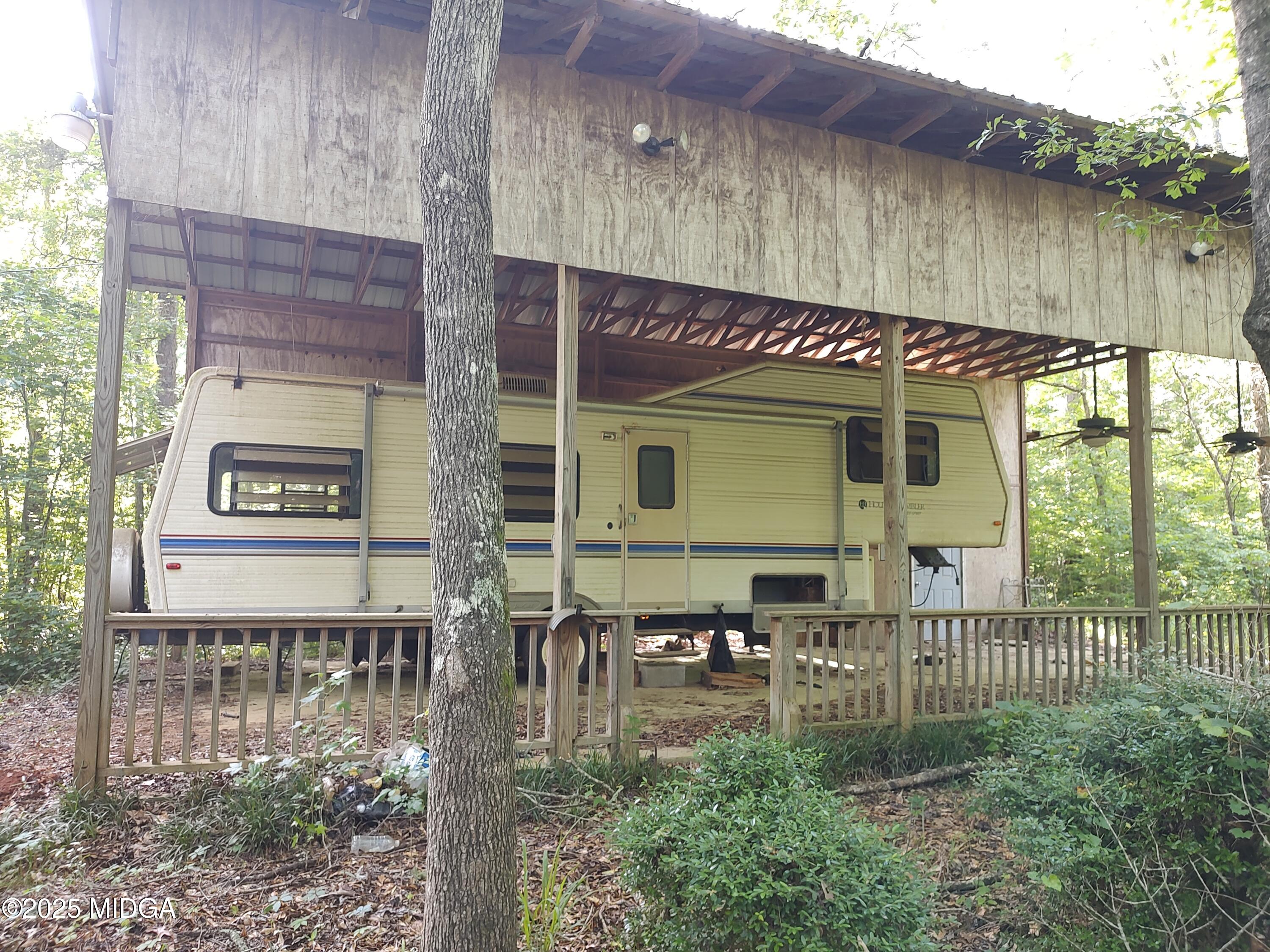 377 Hillsboro Lake Road Hillsboro, GA 31038 - Photo 6 of 6 a view of a chairs and table in the patio
