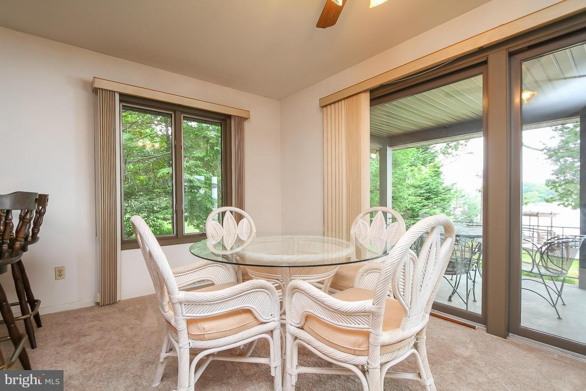 1701 Wilson Point Road Baltimore, MD 21220 - Photo 9 of 27 a dining room with furniture a chandelier and glass door