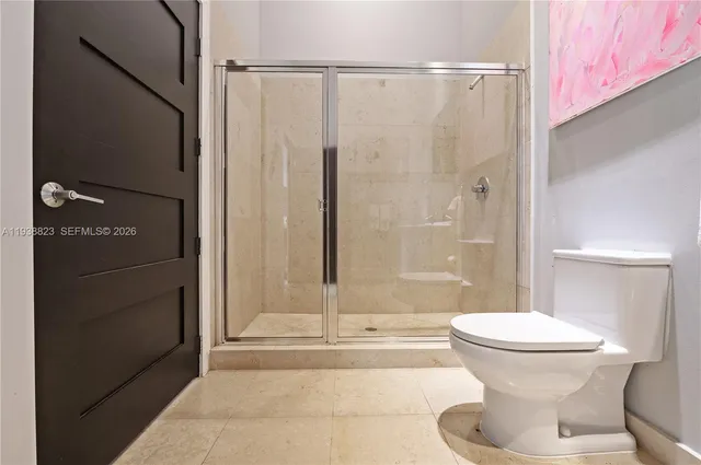 a room with a baby bed couch and a window