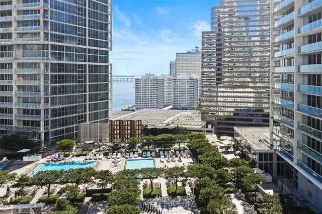 a view of swimming pool with outdoor seating and lake view