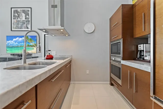a kitchen with stainless steel appliances granite countertop a refrigerator and a stove top oven
