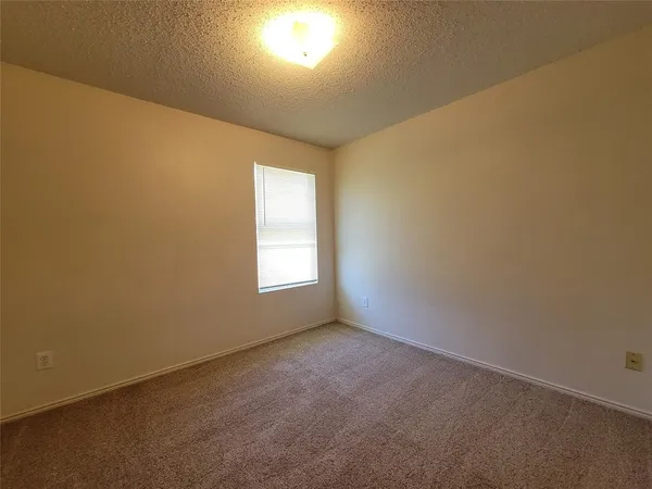 an empty room with a empty space and a window