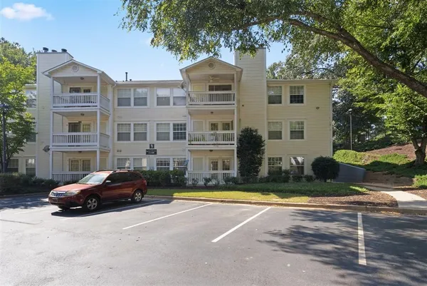 a front view of a residential apartment building with a yard