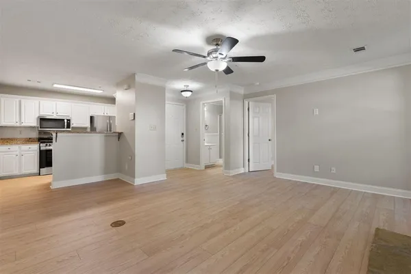 a view of a kitchen with a sink and a refrigerator