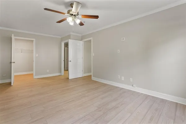a view of an empty room with wooden floor