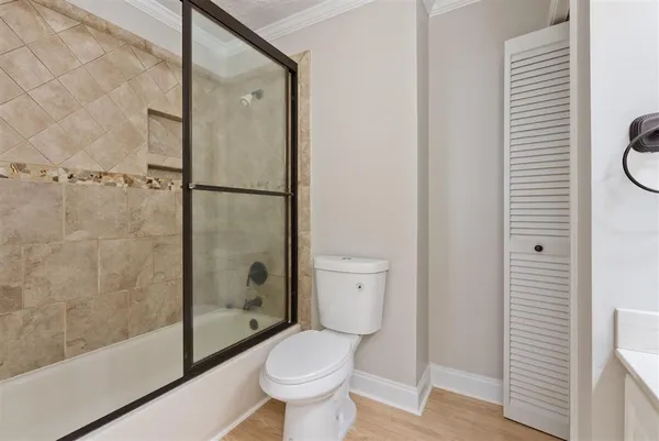 a bathroom with a toilet and a shower
