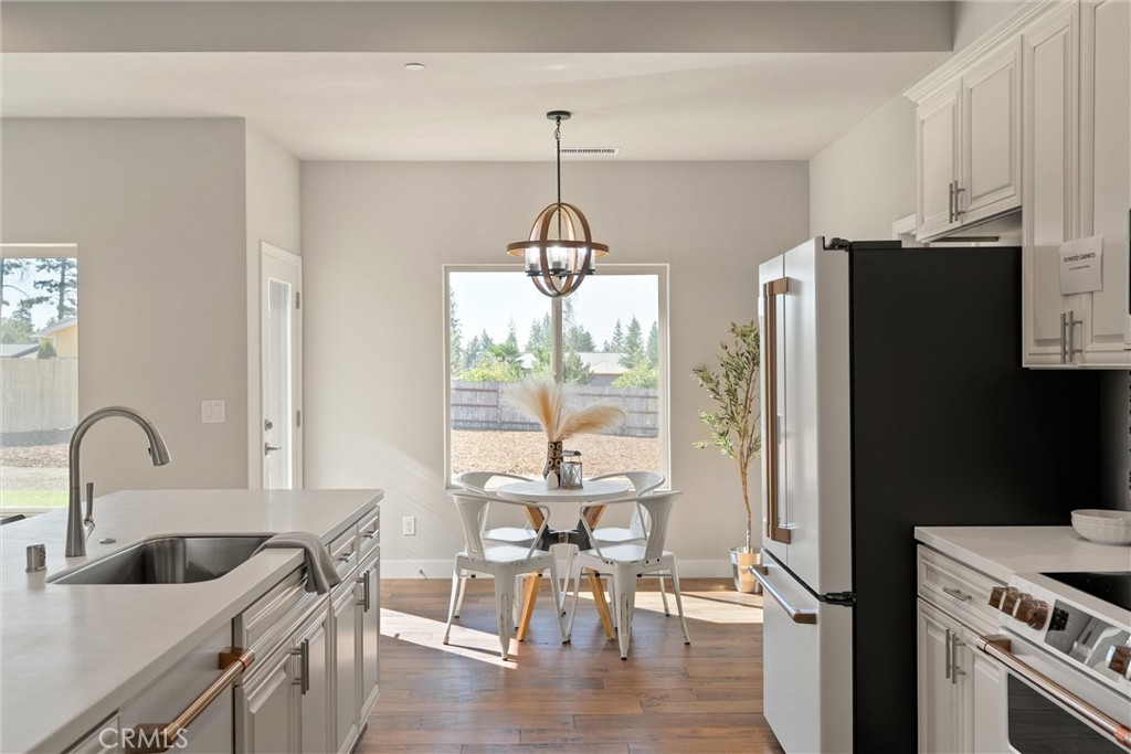 480 Valley View Drive Paradise, CA 95969 - Photo 15 of 48 a kitchen with stainless steel appliances granite countertop a refrigerator a sink a stove and white cabinets