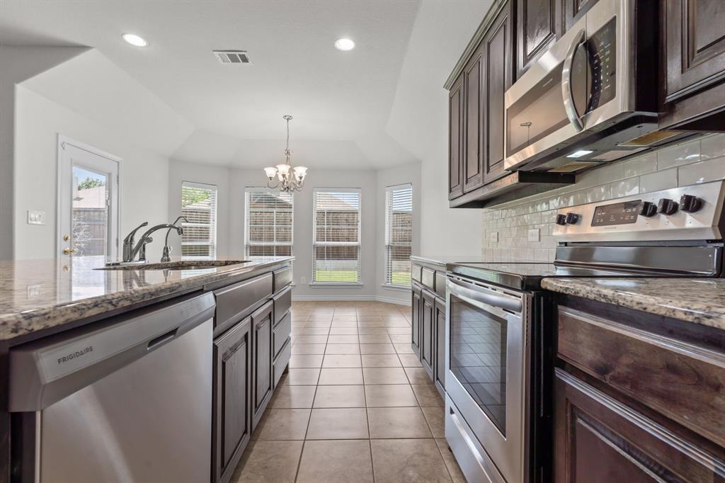 217 Angelina Court Azle, TX 76020 - Photo 11 of 34 a kitchen with stainless steel appliances granite countertop a sink and stove
