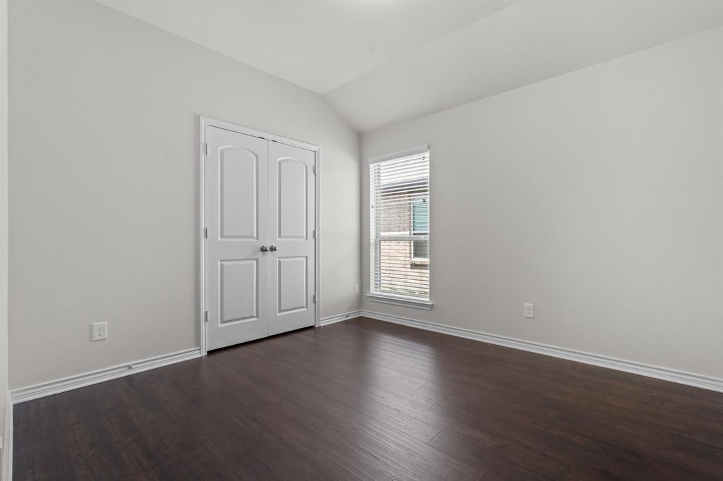 217 Angelina Court Azle, TX 76020 - Photo 13 of 34 an empty room with wooden floor and windows