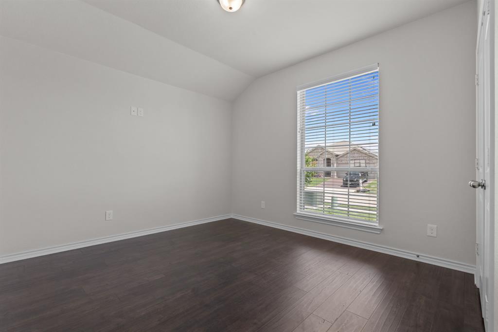 217 Angelina Court Azle, TX 76020 - Photo 15 of 34 an empty room with wooden floor and windows