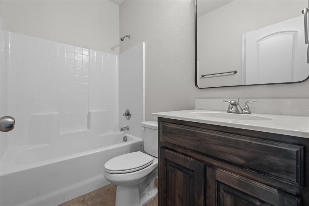 217 Angelina Court Azle, TX 76020 - Photo 16 of 34 a bathroom with a sink a toilet and shower