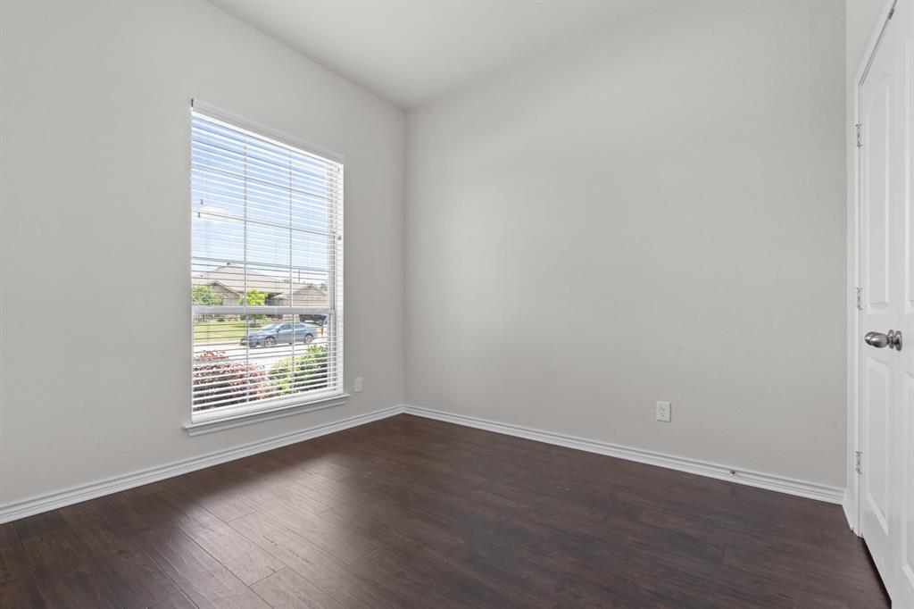 217 Angelina Court Azle, TX 76020 - Photo 19 of 34 an empty room with wooden floor and windows