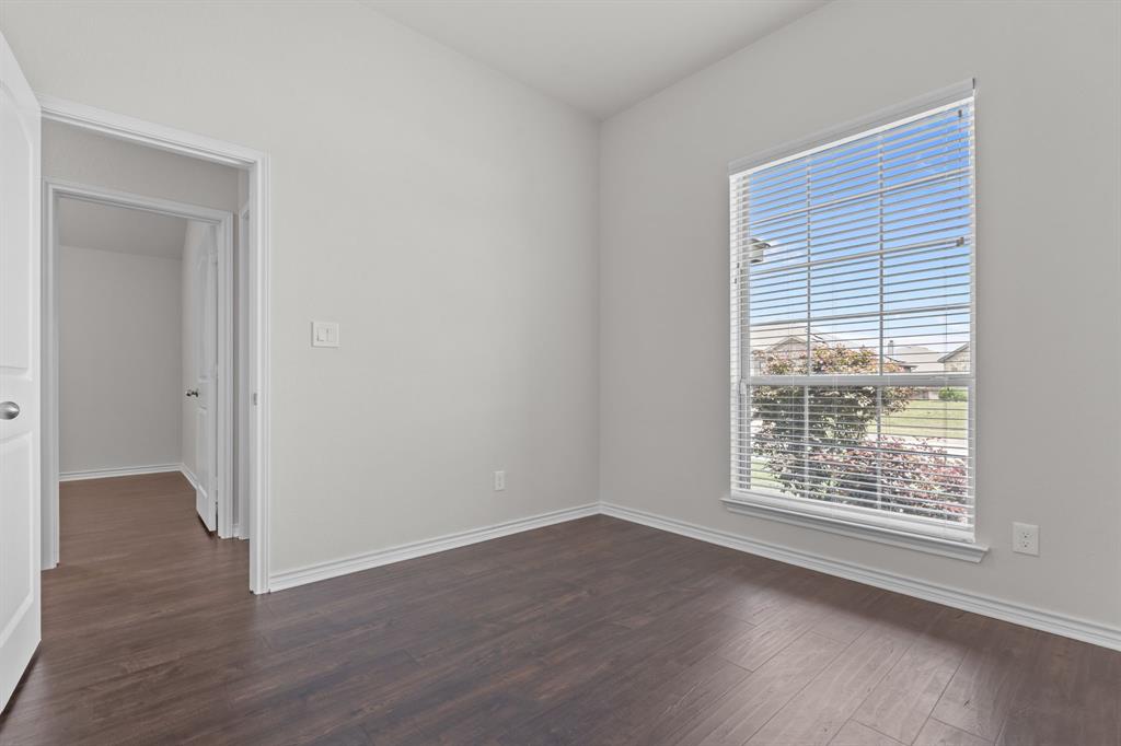 217 Angelina Court Azle, TX 76020 - Photo 20 of 34 an empty room with wooden floor and windows