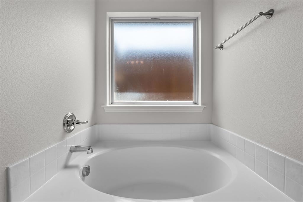 217 Angelina Court Azle, TX 76020 - Photo 25 of 34 a white bath tub sitting in a bathroom