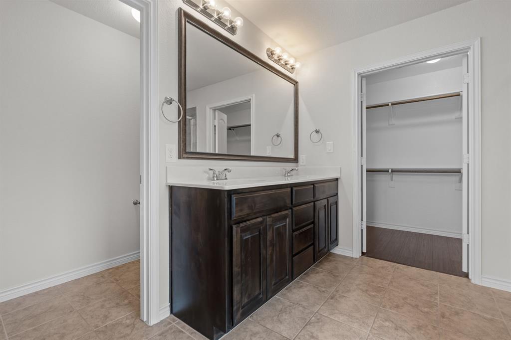 217 Angelina Court Azle, TX 76020 - Photo 26 of 34 a bathroom with a sink and a mirror