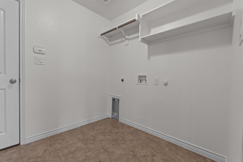 217 Angelina Court Azle, TX 76020 - Photo 28 of 34 a view of a room with racks on the wall
