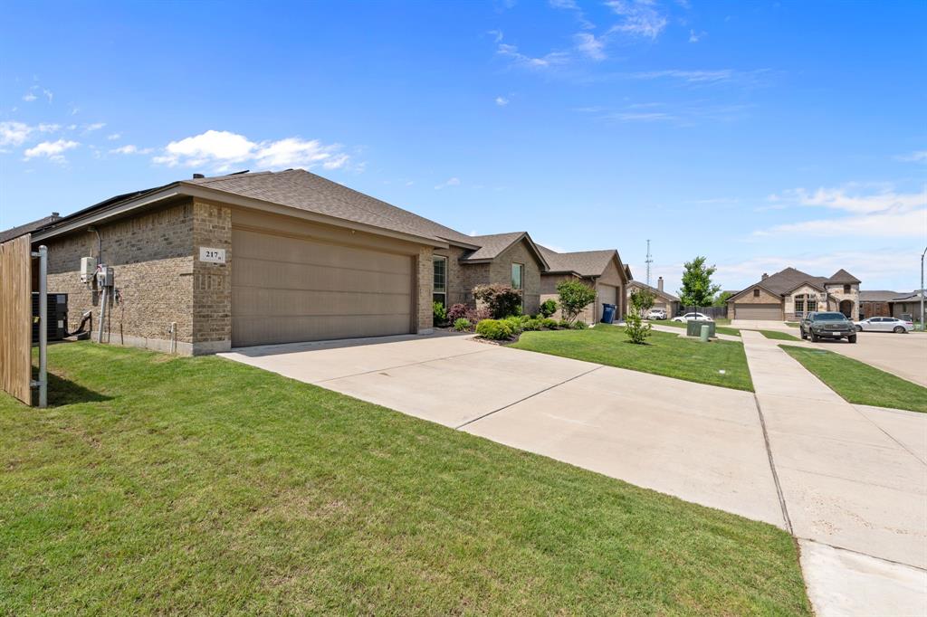 217 Angelina Court Azle, TX 76020 - Photo 34 of 34 a front view of a house with a yard and garage