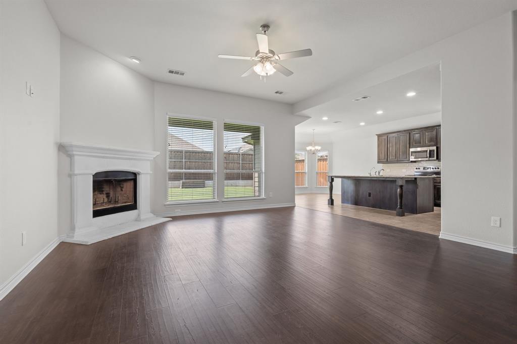 217 Angelina Court Azle, TX 76020 - Photo 5 of 34 wooden floor fireplace and windows in an empty room
