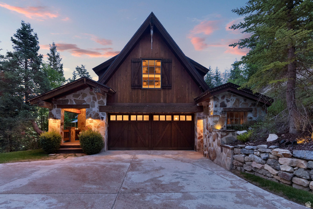 2983 East Ridgetop Road, Unit 27 Provo, UT 84604 - Photo 56 of 63 Modern A-frame residence featuring a striking dark wood and stone exterior with illuminated multi-pane gable window