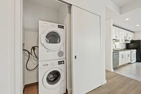 a utility room with sink dryer and washer